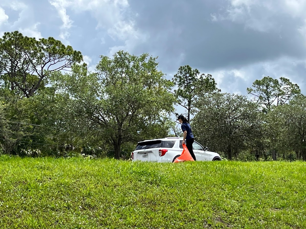 Image of Jason Wang digging a hole to plant the precious friut trees.