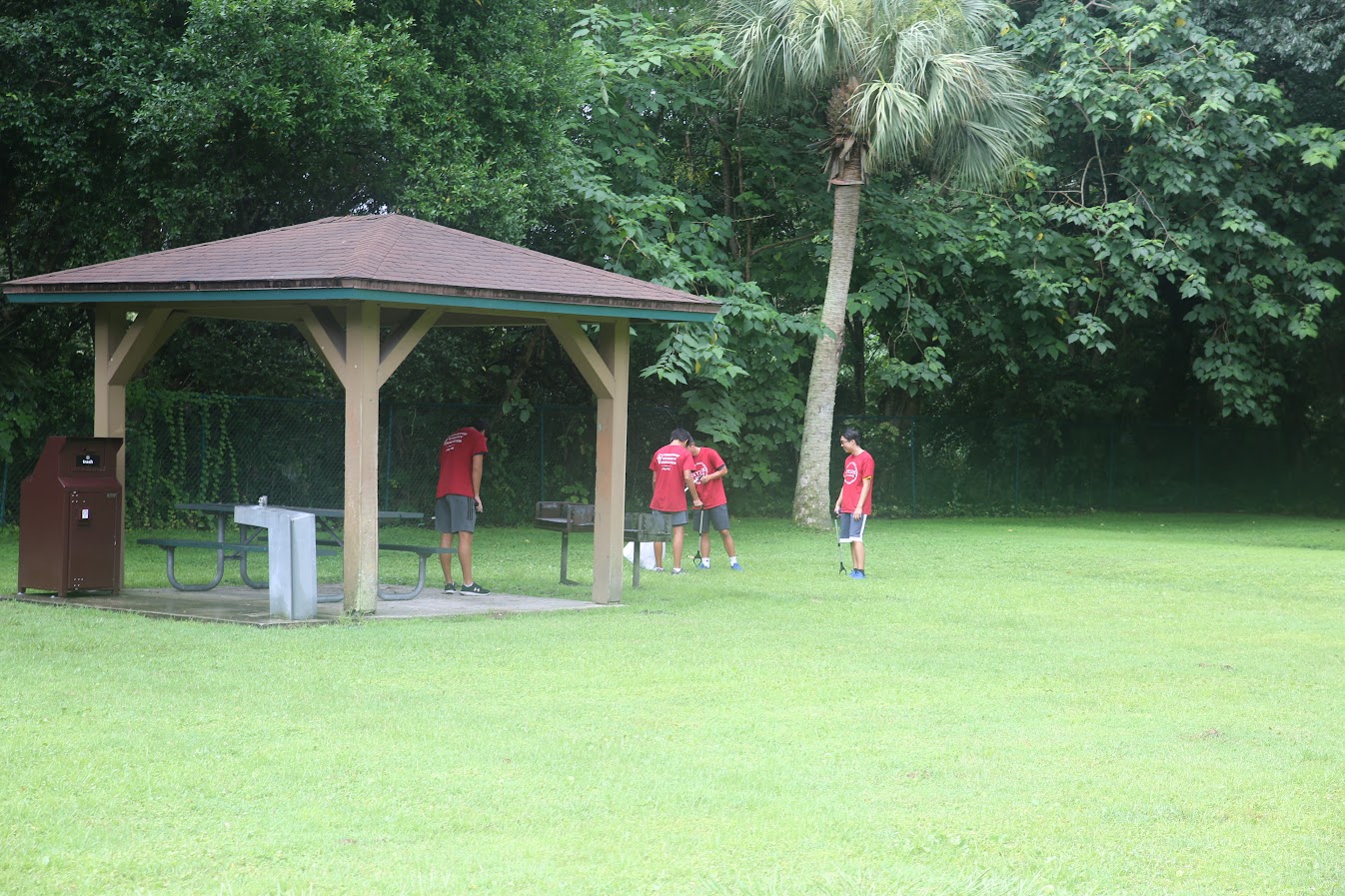 Image of Jason Wang digging a hole to plant the precious friut trees.